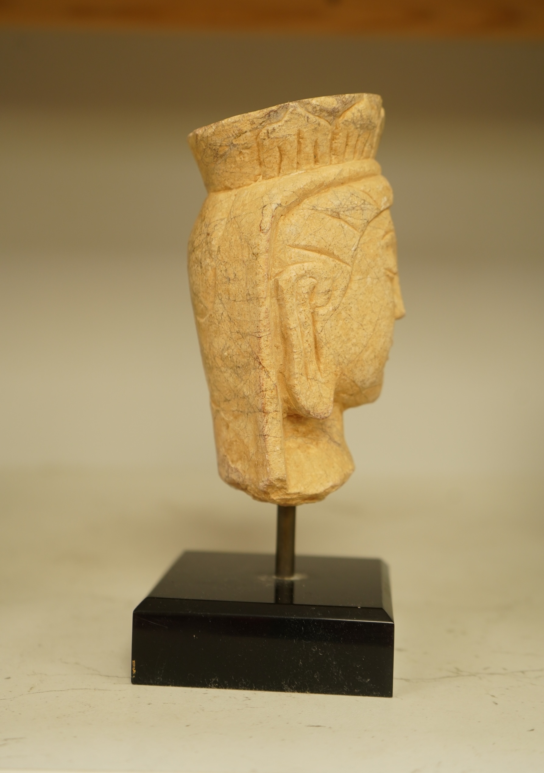 A composition bust of Bodhisattva, possibly Tibetan, on stand, 18cm high